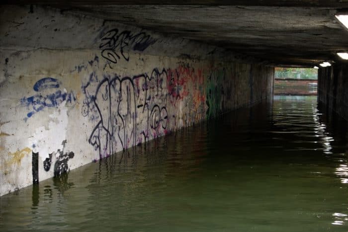 Flooded pedestrian underpass in Salisbury showing high water levels after a pump failure caused by debris
