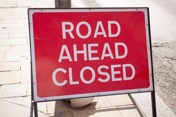 Road closure sign ahead of surface dressing remedial works.