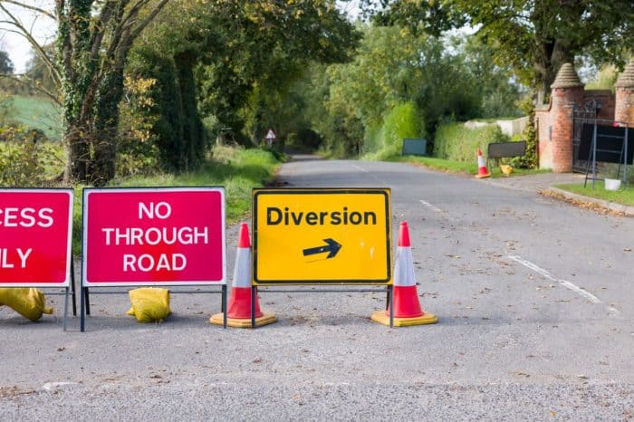 Road closed sign on a rural road during resurfacing works.