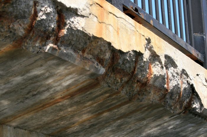 Concrete breaking away from a bridge edge